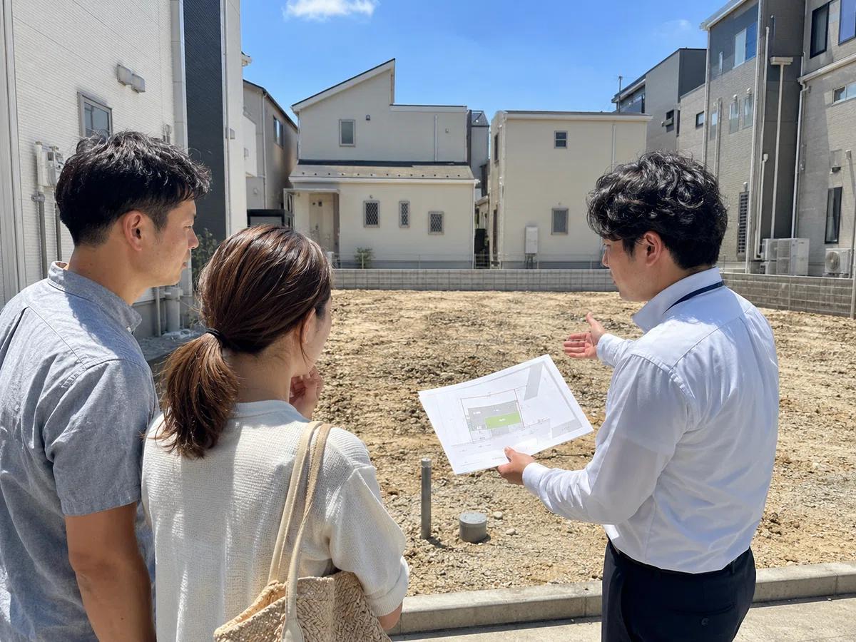 Couple reviewing a buildable residential lot with a real estate professional in a new California development