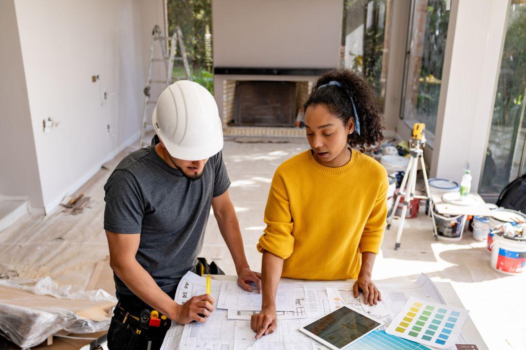 First-time real estate investor discussing a fix and flip renovation with a contractor